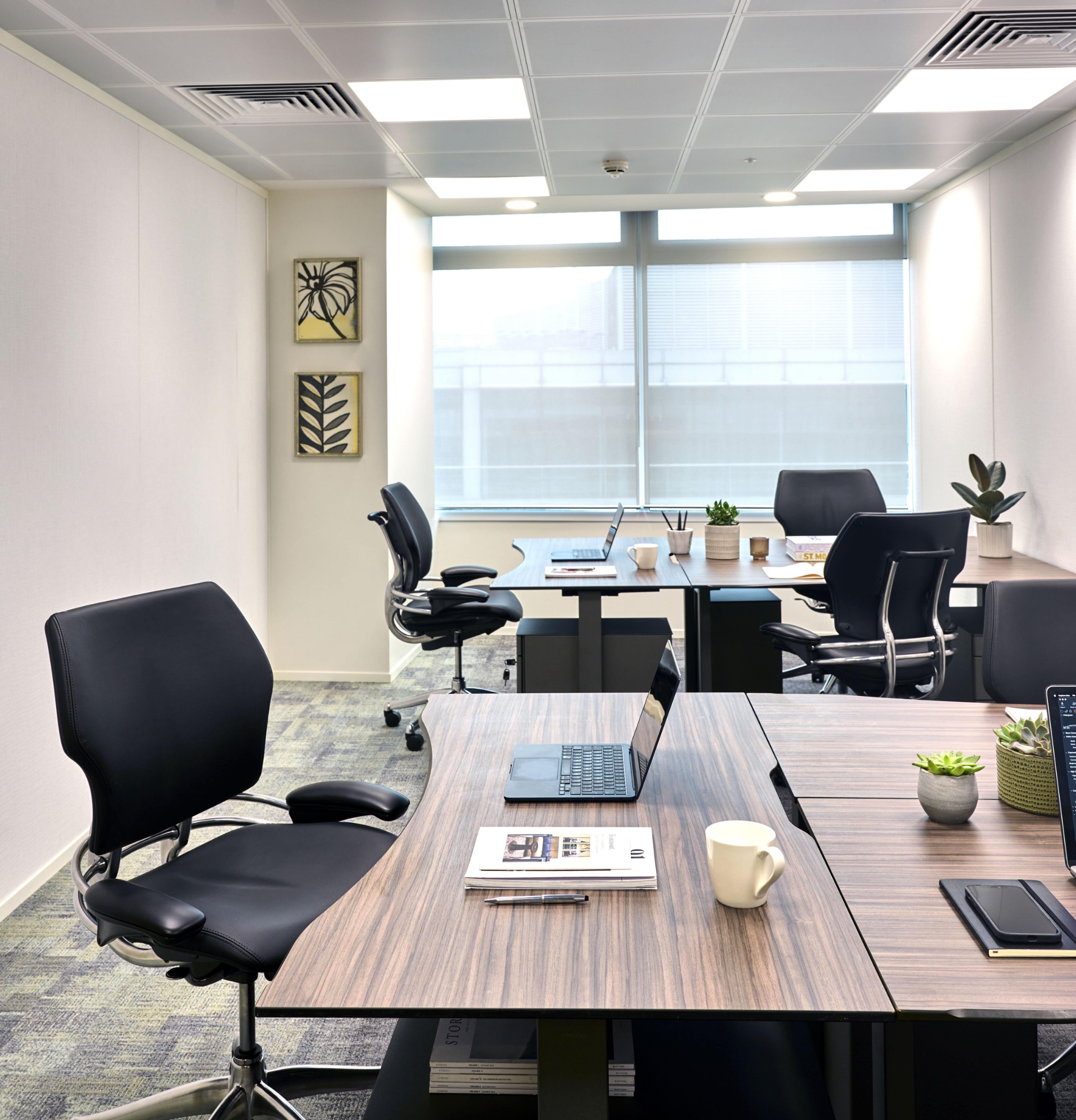 Fully furnished private office at Beaumont Midtown featuring contemporary workstations, natural light and a professional working environment.